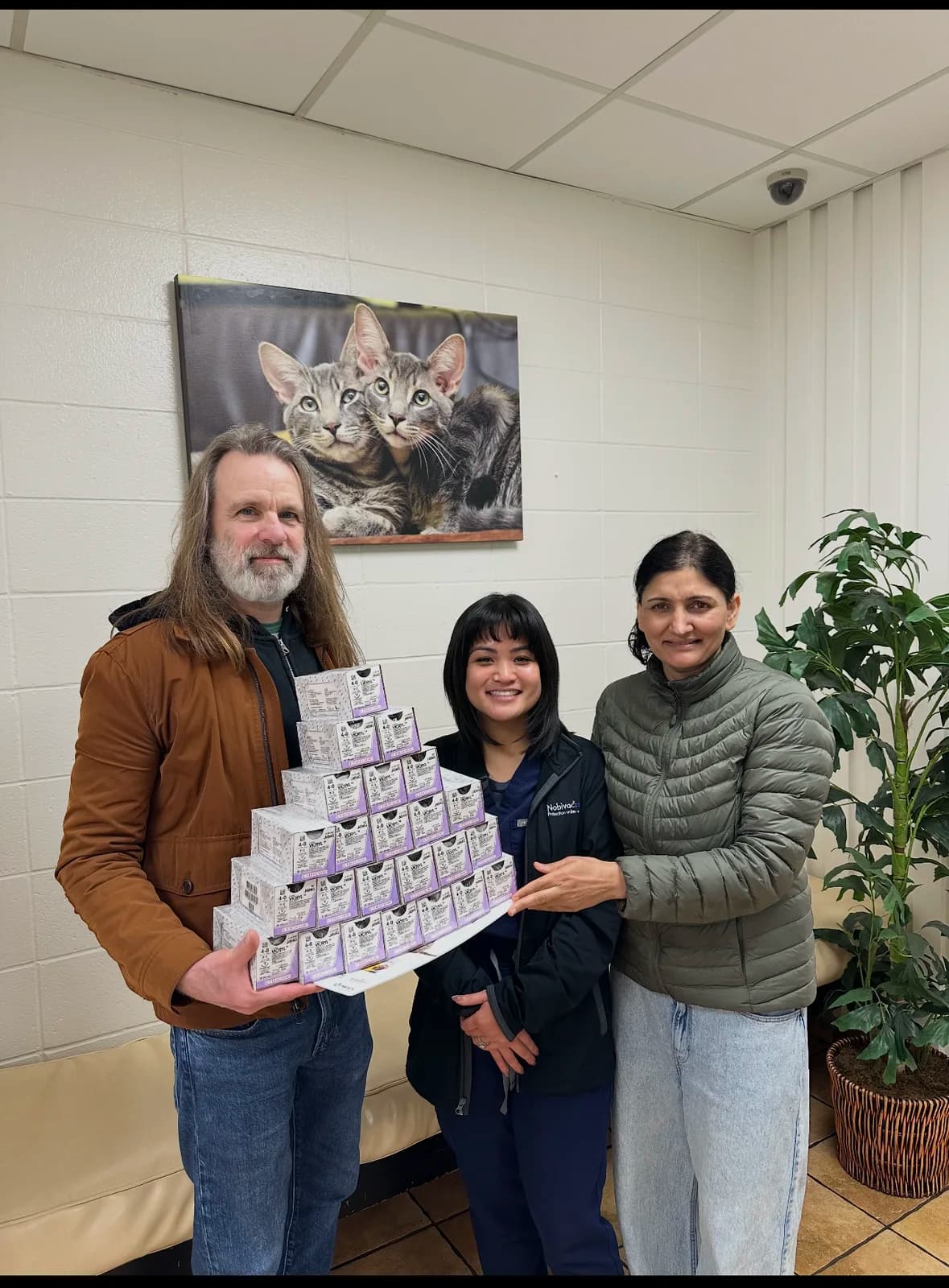 Save The Foster presenting collected surgical sutures with local veterinary professionals