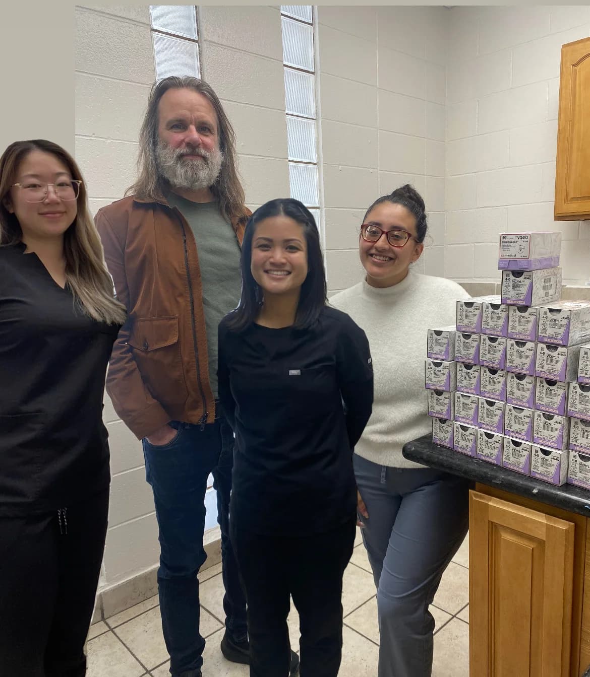 Veterinary professionals with surgical sutures collected for donation in 2023